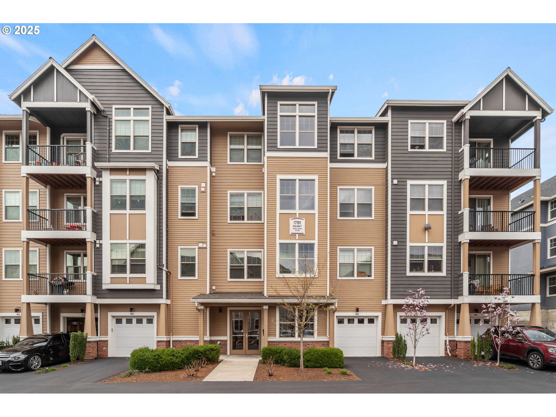 17181 Southwest Snowdale Street, Unit 204 Beaverton, OR 97007 - Photo 1 of 13 a front view of a residential apartment building with a yard
