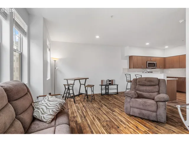 a living room with furniture and kitchen view