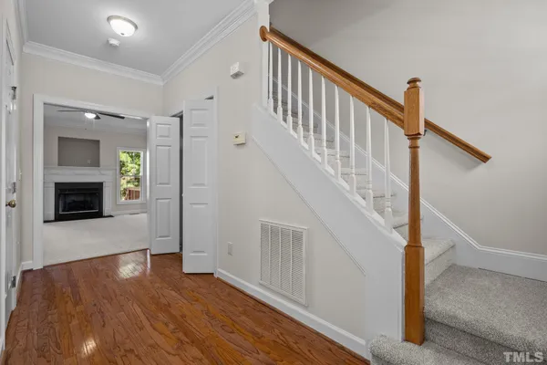 a view of a hallway with wooden floor and entryway