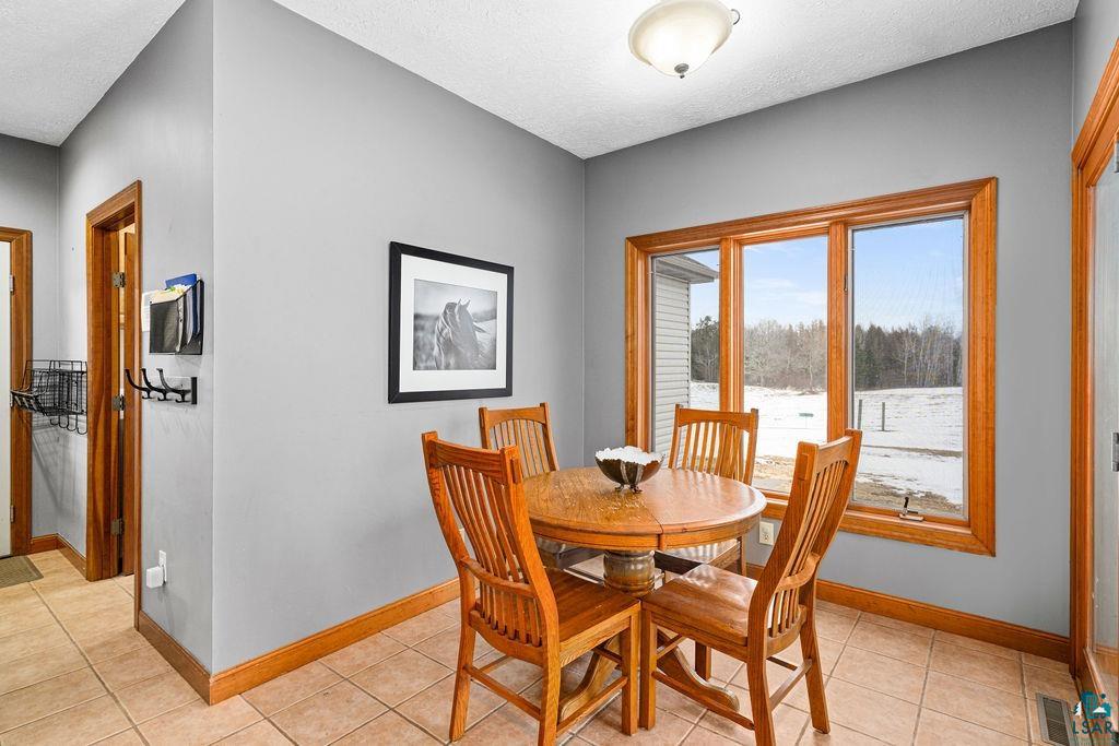 2542 Ziehl Road Carlton, MN 55718 - Photo 18 of 51 Dining area with light tile patterned floors and a textured ceiling