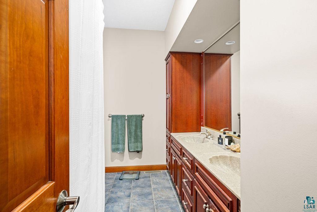 2542 Ziehl Road Carlton, MN 55718 - Photo 24 of 51 Bathroom with double vanity and curtained shower