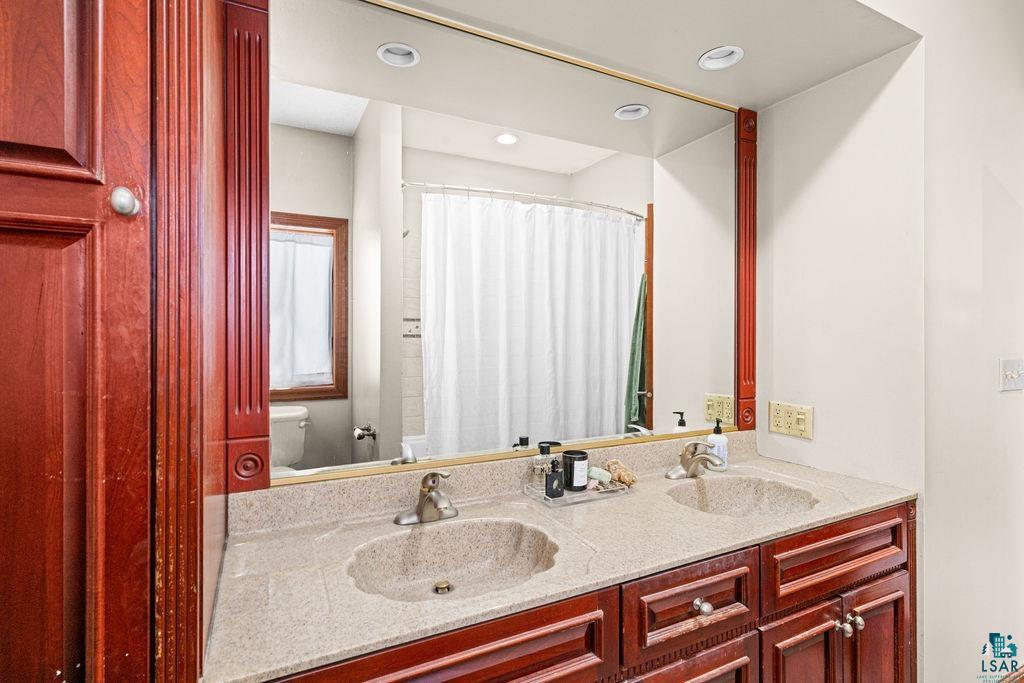 2542 Ziehl Road Carlton, MN 55718 - Photo 25 of 51 Bathroom with double vanity and a shower with curtain