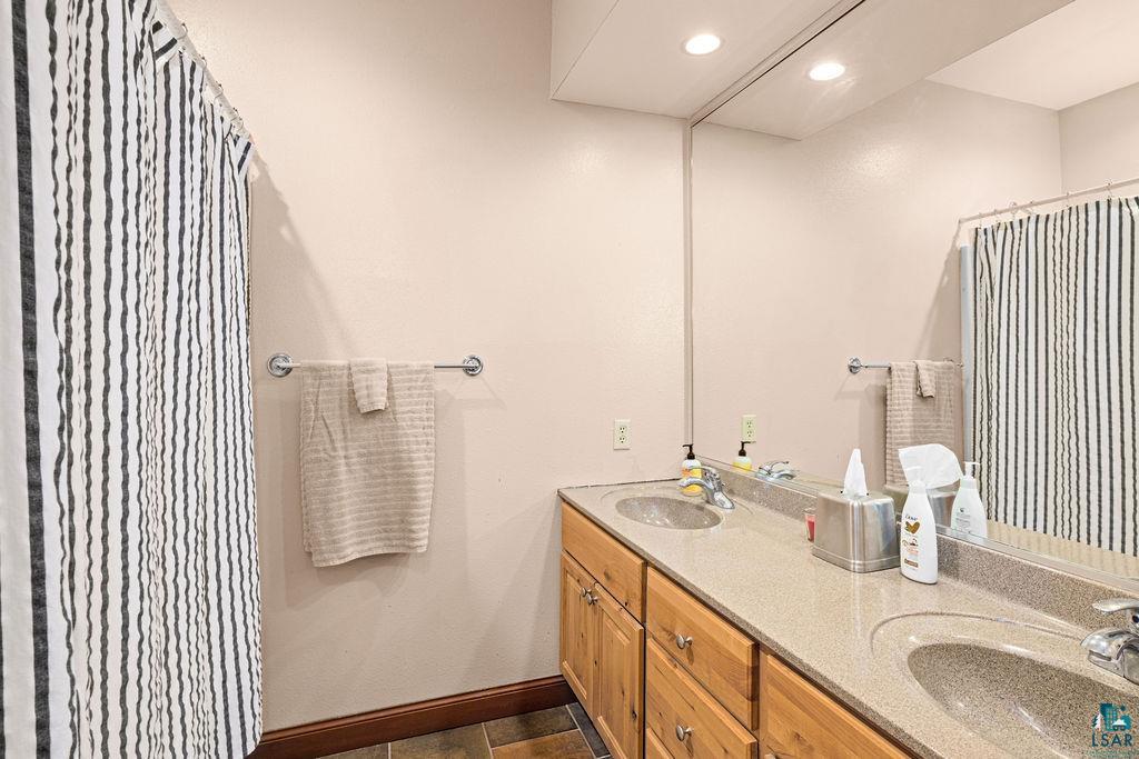 2542 Ziehl Road Carlton, MN 55718 - Photo 40 of 51 Bathroom with double vanity, a shower with curtain, and recessed lighting