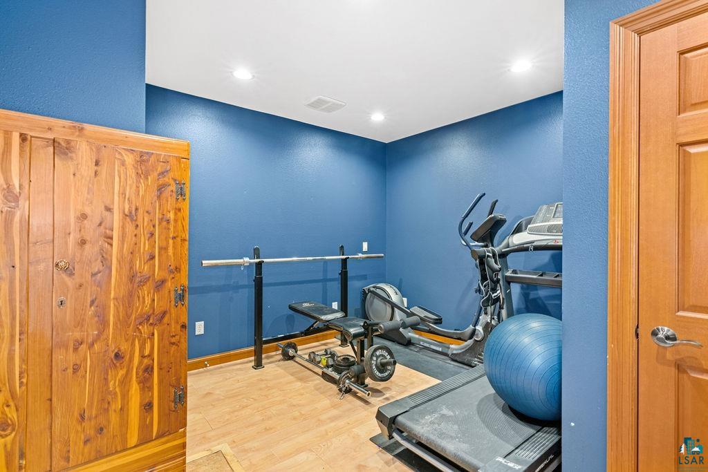 2542 Ziehl Road Carlton, MN 55718 - Photo 44 of 51 Workout area featuring light wood-type flooring, a textured wall, and recessed lighting