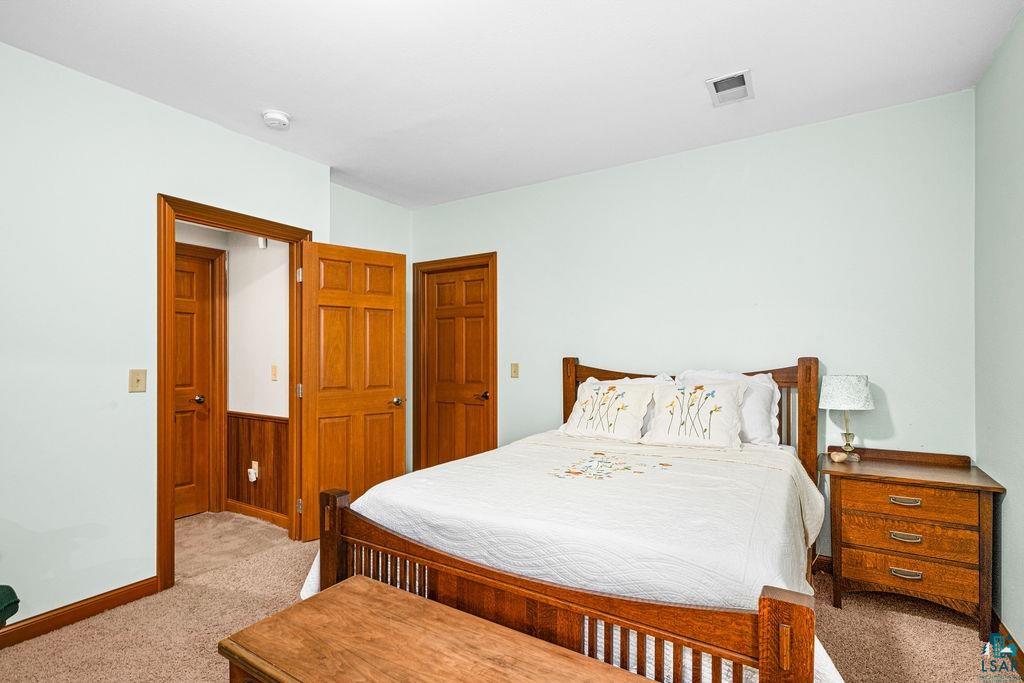 2542 Ziehl Road Carlton, MN 55718 - Photo 46 of 51 Bedroom with light colored carpet and baseboards