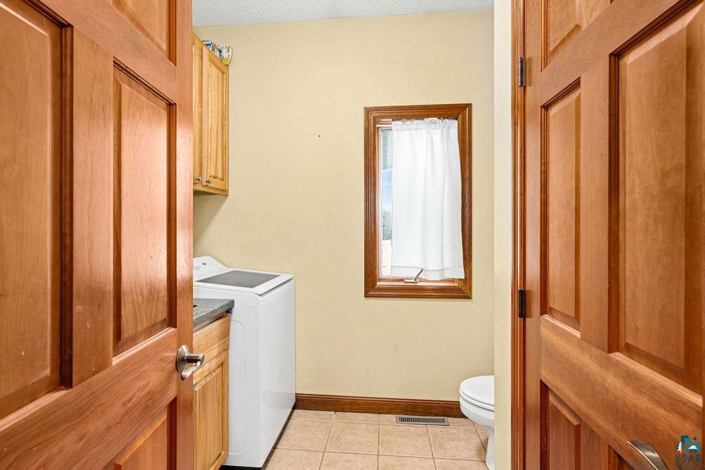 2542 Ziehl Road Carlton, MN 55718 - Photo 50 of 51 Laundry area featuring baseboards and light tile patterned flooring