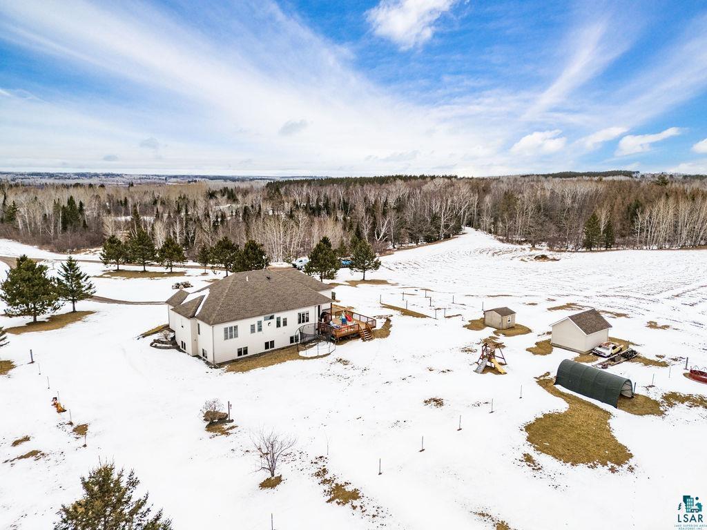 2542 Ziehl Road Carlton, MN 55718 - Photo 5 of 51 Snowy aerial view featuring a wooded view