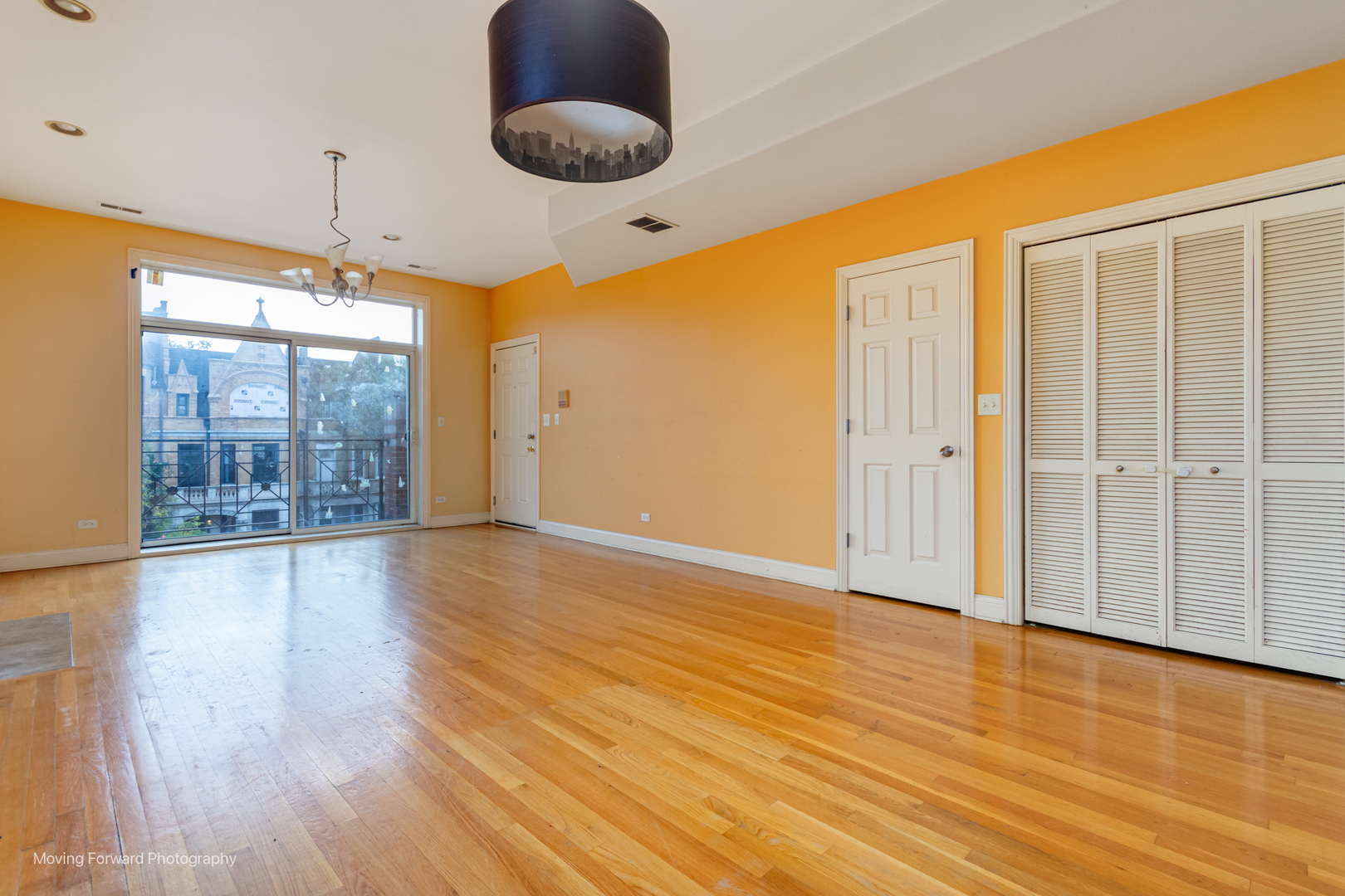 4900 South Vincennes Avenue, Unit 3 Chicago, IL 60615 - Photo 14 of 27 a view of an empty room with wooden floor and a window