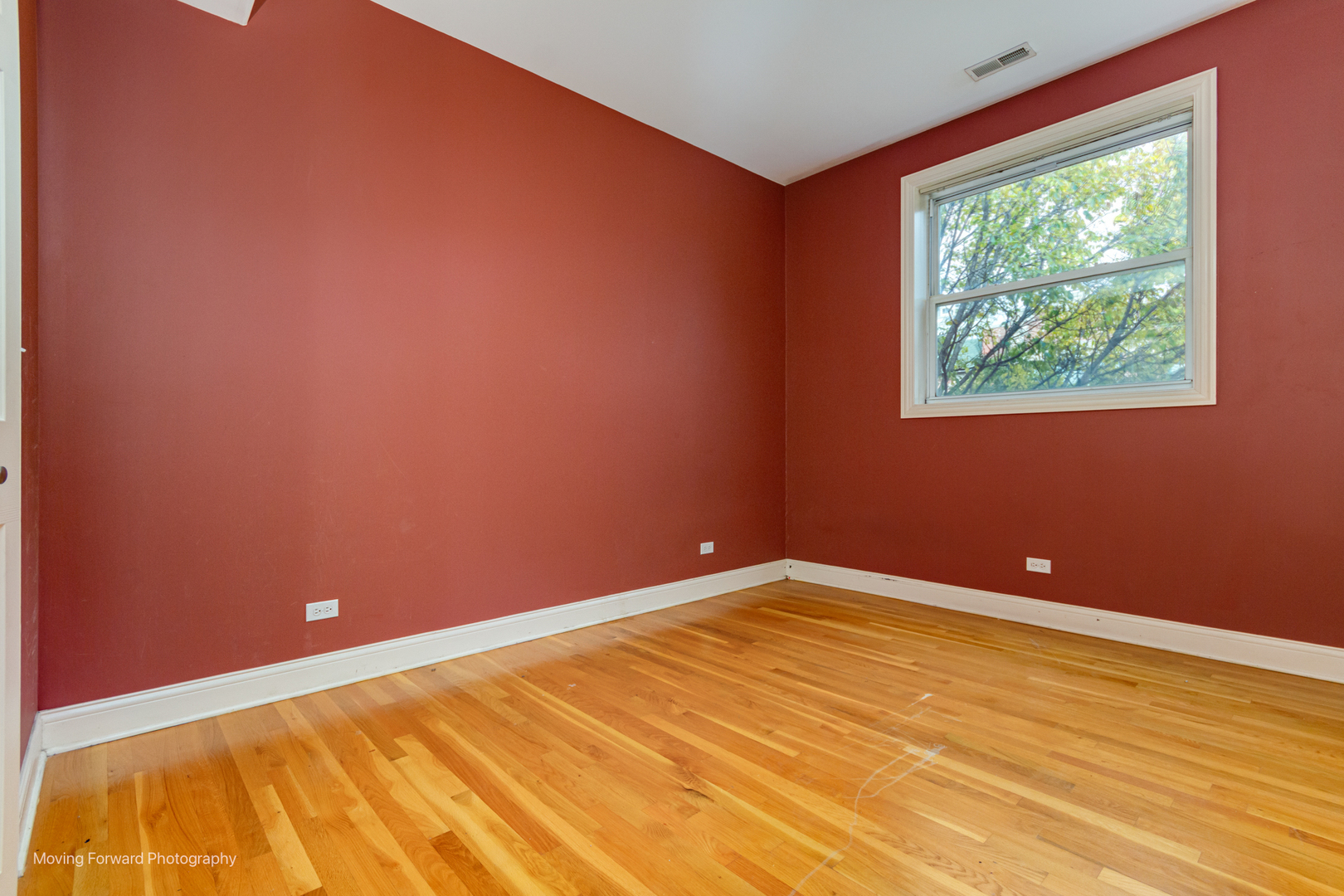 4900 South Vincennes Avenue, Unit 3 Chicago, IL 60615 - Photo 20 of 27 a view of an empty room with wooden floor and a window