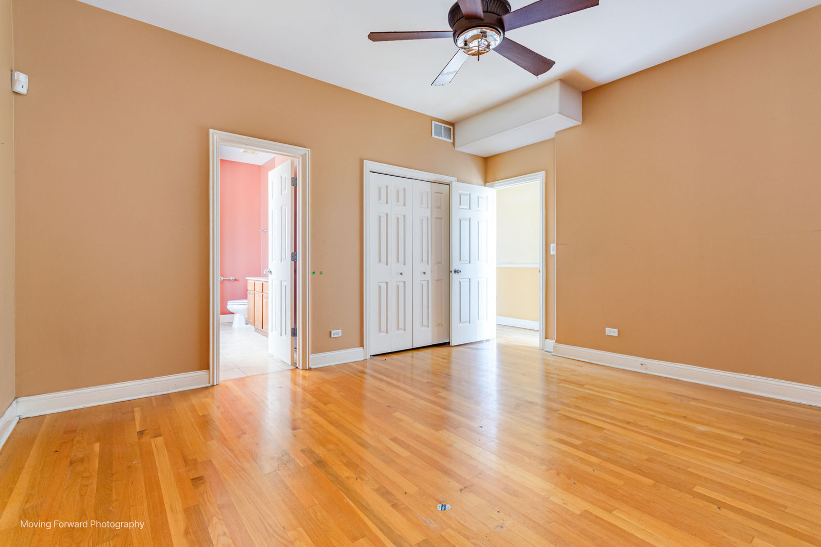4900 South Vincennes Avenue, Unit 3 Chicago, IL 60615 - Photo 24 of 27 an empty room with wooden floor fan and windows