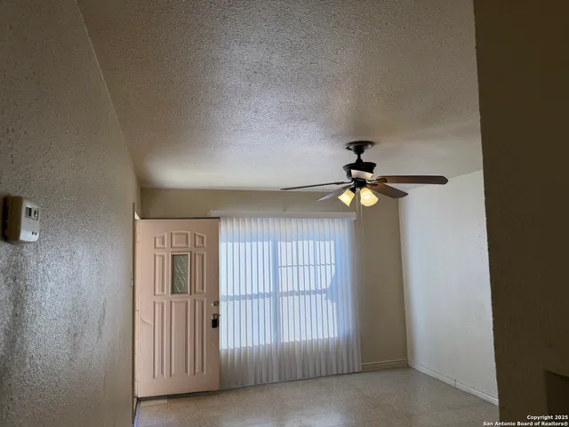 a view of a chandelier fan and windows