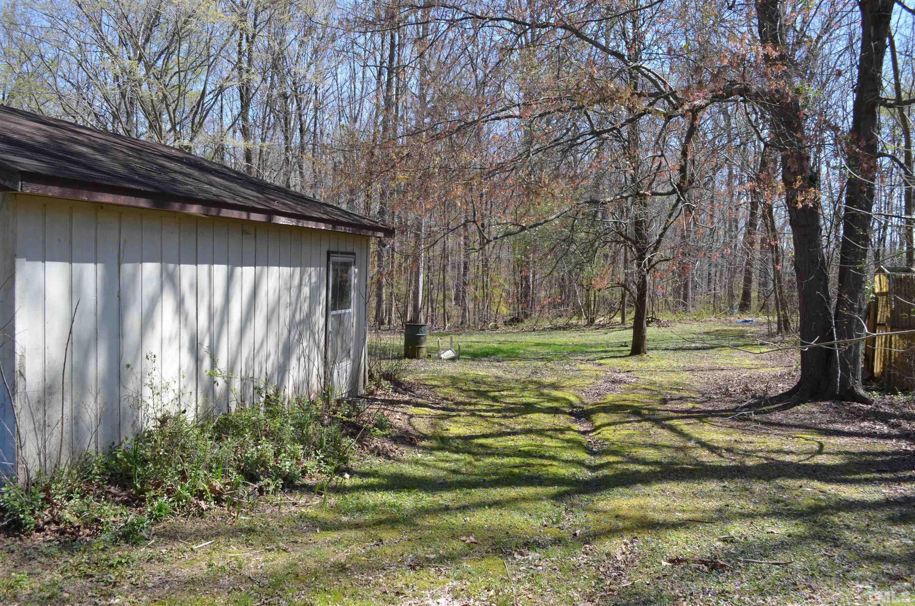 123 Joe Brown Road Bear Creek, NC 27207 - Photo 19 of 32 a view of a backyard with large trees