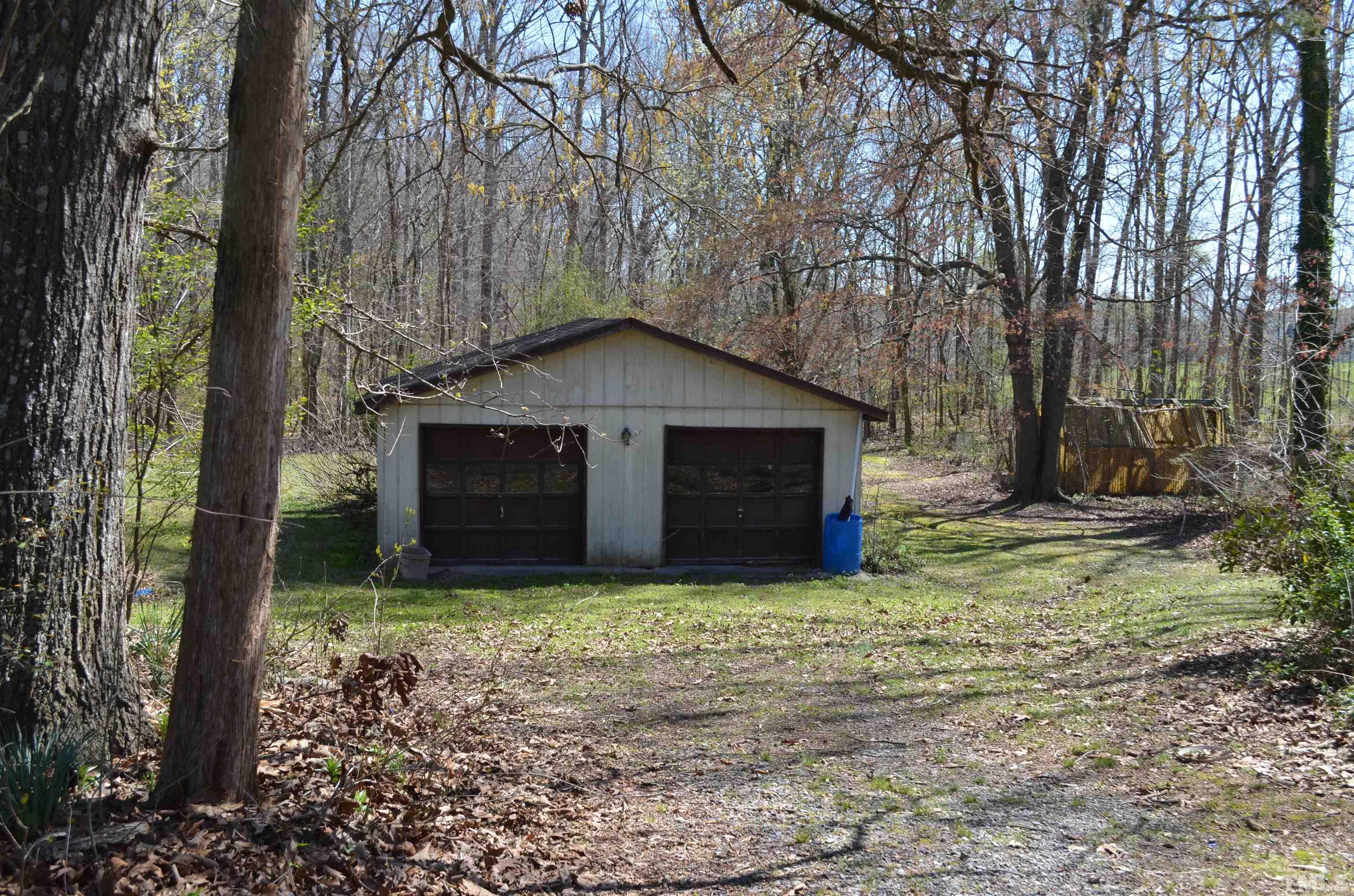 123 Joe Brown Road Bear Creek, NC 27207 - Photo 28 of 32 a front view of a house with yard and trees