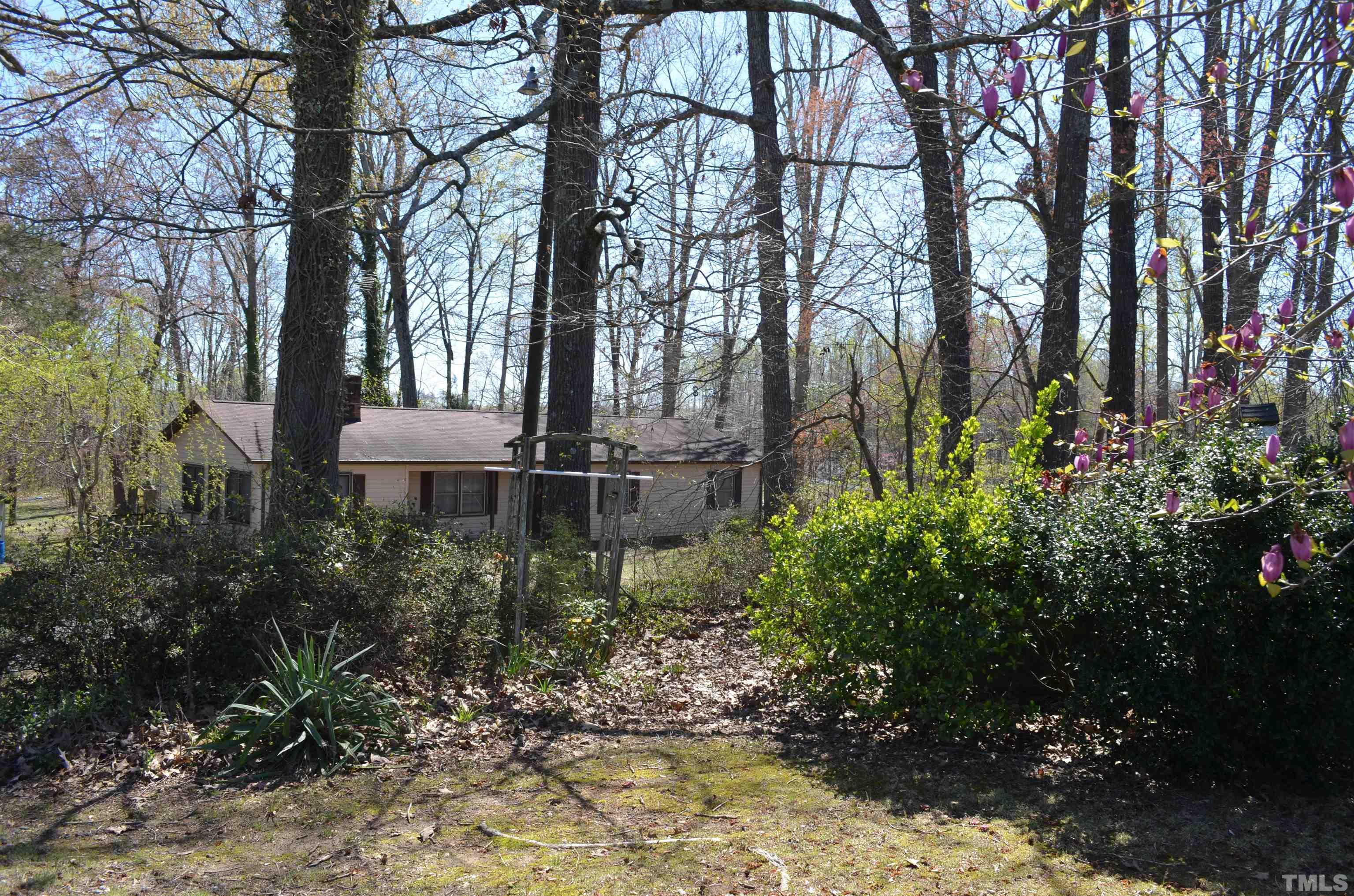 123 Joe Brown Road Bear Creek, NC 27207 - Photo 32 of 32 a view of a house with large trees and plants