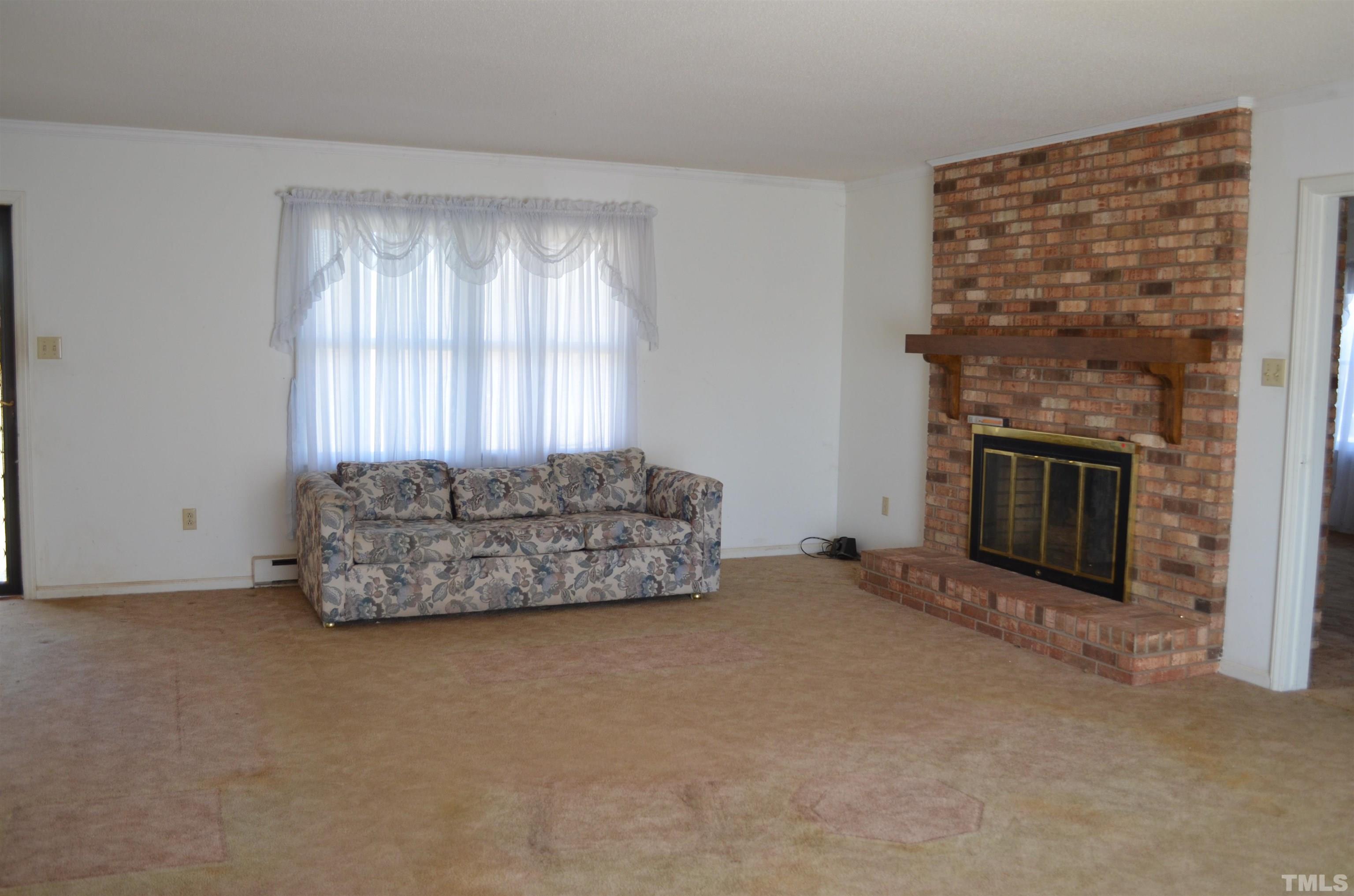 123 Joe Brown Road Bear Creek, NC 27207 - Photo 5 of 32 a living room with furniture and a fireplace