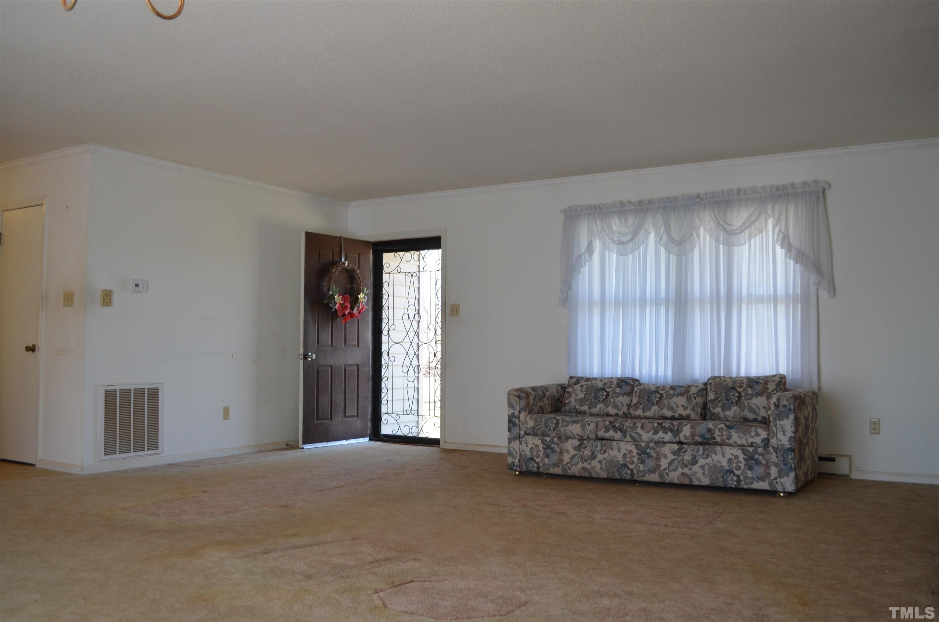 123 Joe Brown Road Bear Creek, NC 27207 - Photo 6 of 32 a living room with furniture and a window