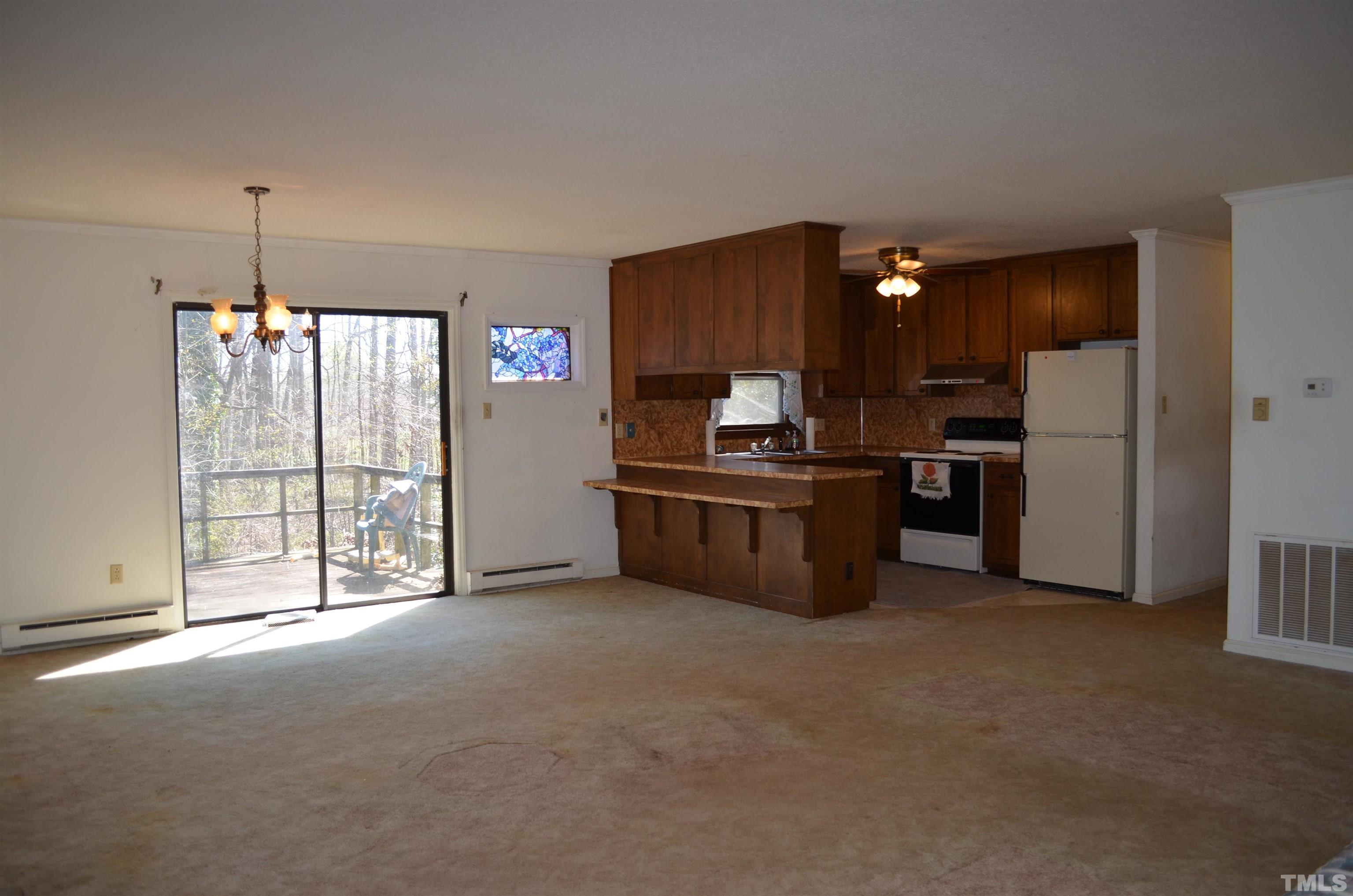 123 Joe Brown Road Bear Creek, NC 27207 - Photo 7 of 32 a kitchen with stainless steel appliances a refrigerator and a sink