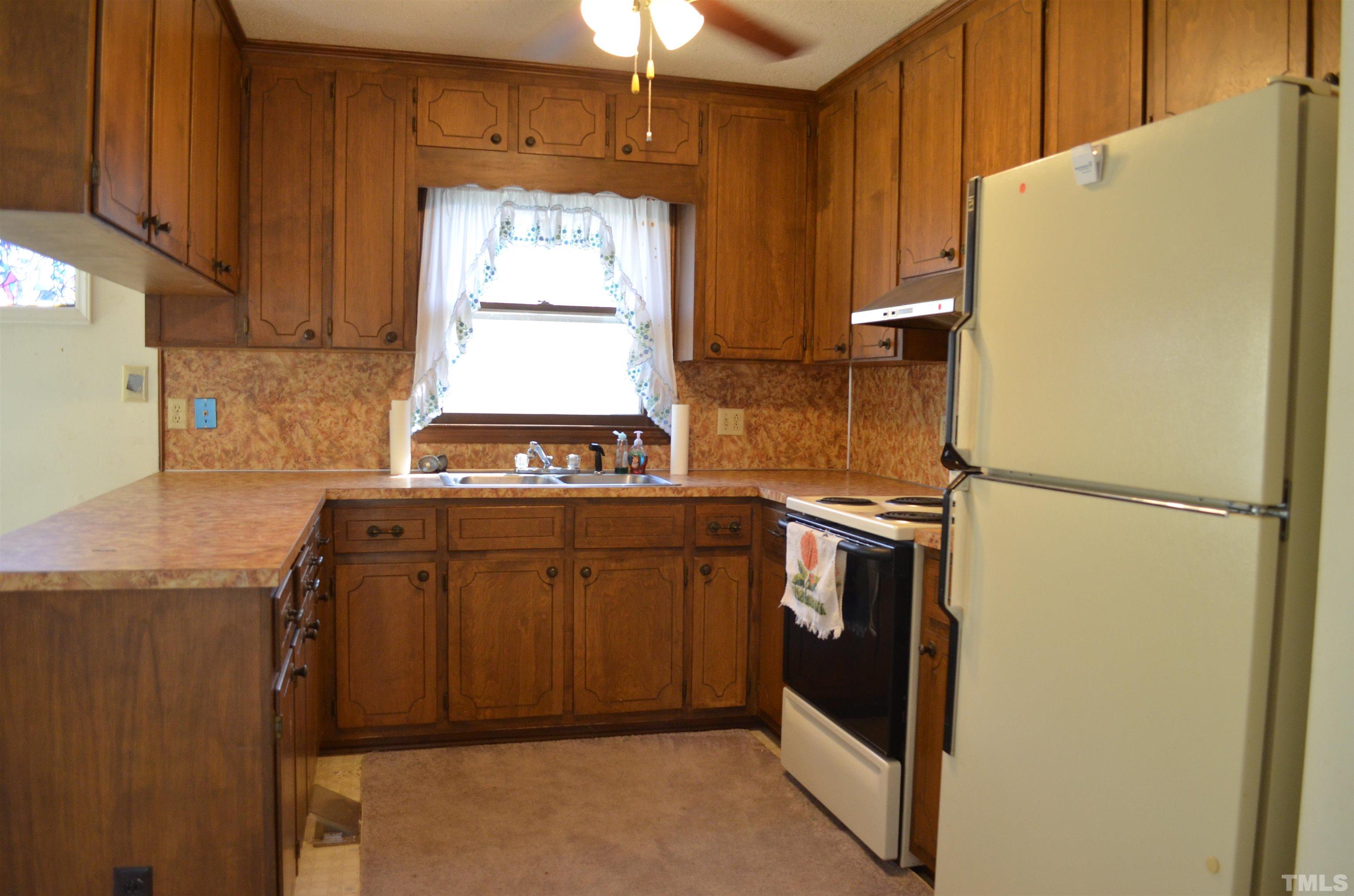 123 Joe Brown Road Bear Creek, NC 27207 - Photo 8 of 32 a kitchen with stainless steel appliances a refrigerator and a stove