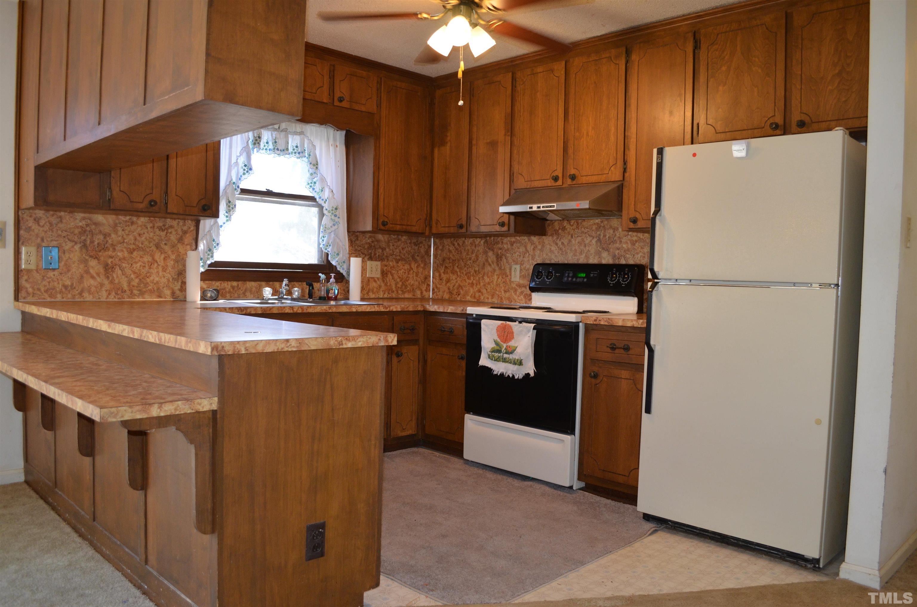 123 Joe Brown Road Bear Creek, NC 27207 - Photo 9 of 32 a kitchen with a stove a refrigerator and a sink