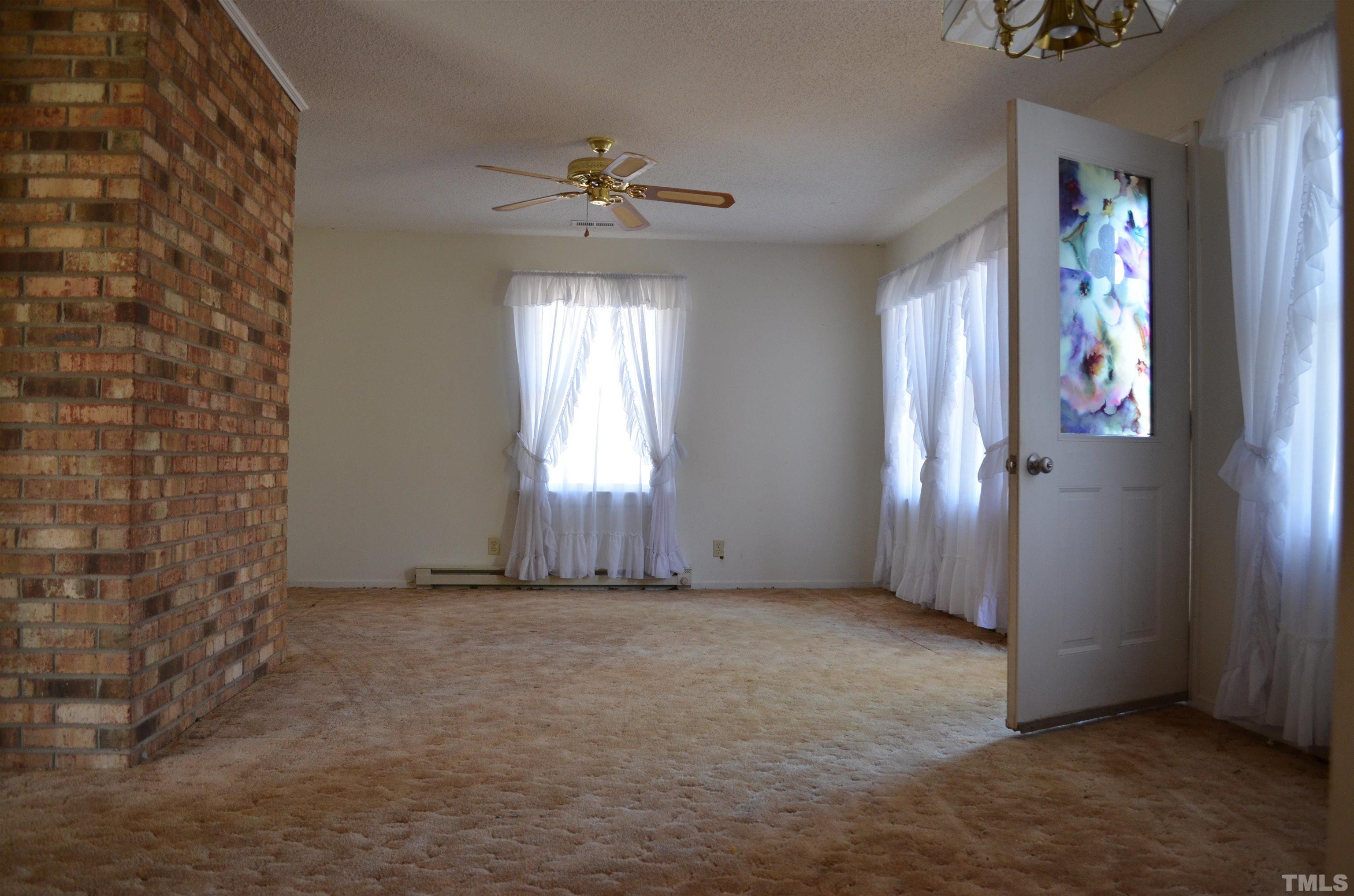 123 Joe Brown Road Bear Creek, NC 27207 - Photo 10 of 32 an empty room with windows and closet