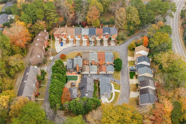 an aerial view of multiple houses with yard