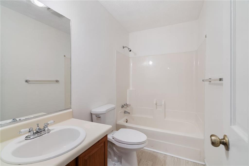 3278 Hampton Green Way Atlanta, GA 30340 - Photo 24 of 28 a bathroom with a sink a toilet and shower