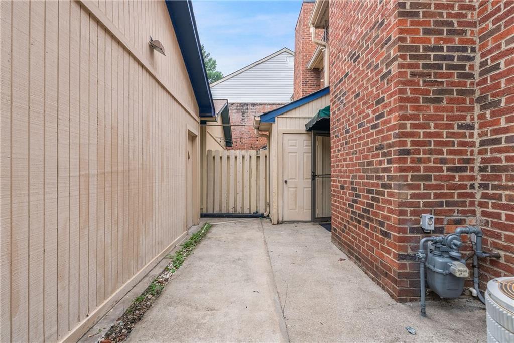 3278 Hampton Green Way Atlanta, GA 30340 - Photo 28 of 28 a view of a brick house with wooden fence