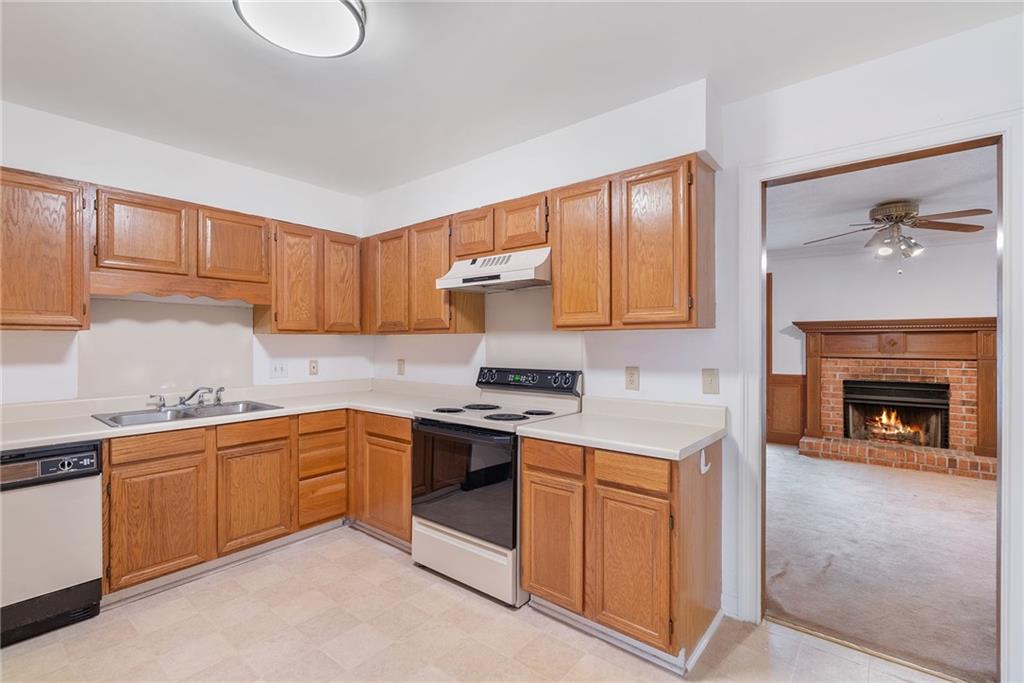 3278 Hampton Green Way Atlanta, GA 30340 - Photo 9 of 28 a kitchen with a sink cabinets and window