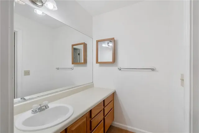 a bathroom with a sink a vanity and a mirror