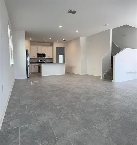 a view of kitchen with kitchen island a sink a stove and a refrigerator