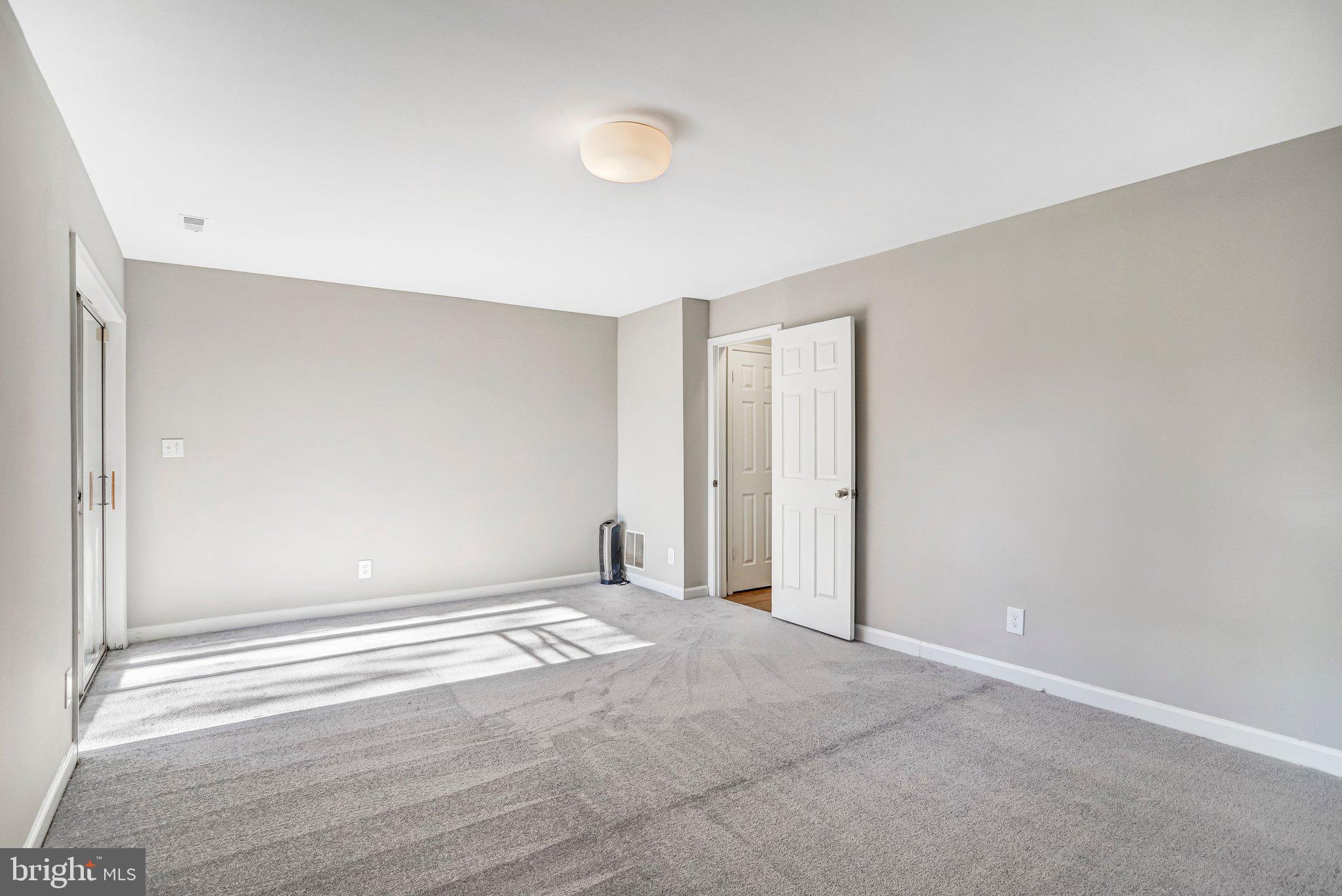 2807 Strauss Terrace Silver Spring, MD 20904 - Photo 22 of 26 a view of an empty room with wooden floor and a window