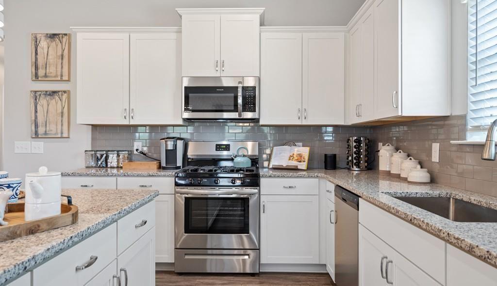 118 Sycamore Lane Calhoun, GA 30701 - Photo 8 of 19 a kitchen with stainless steel appliances granite countertop a sink a stove and a granite counter tops