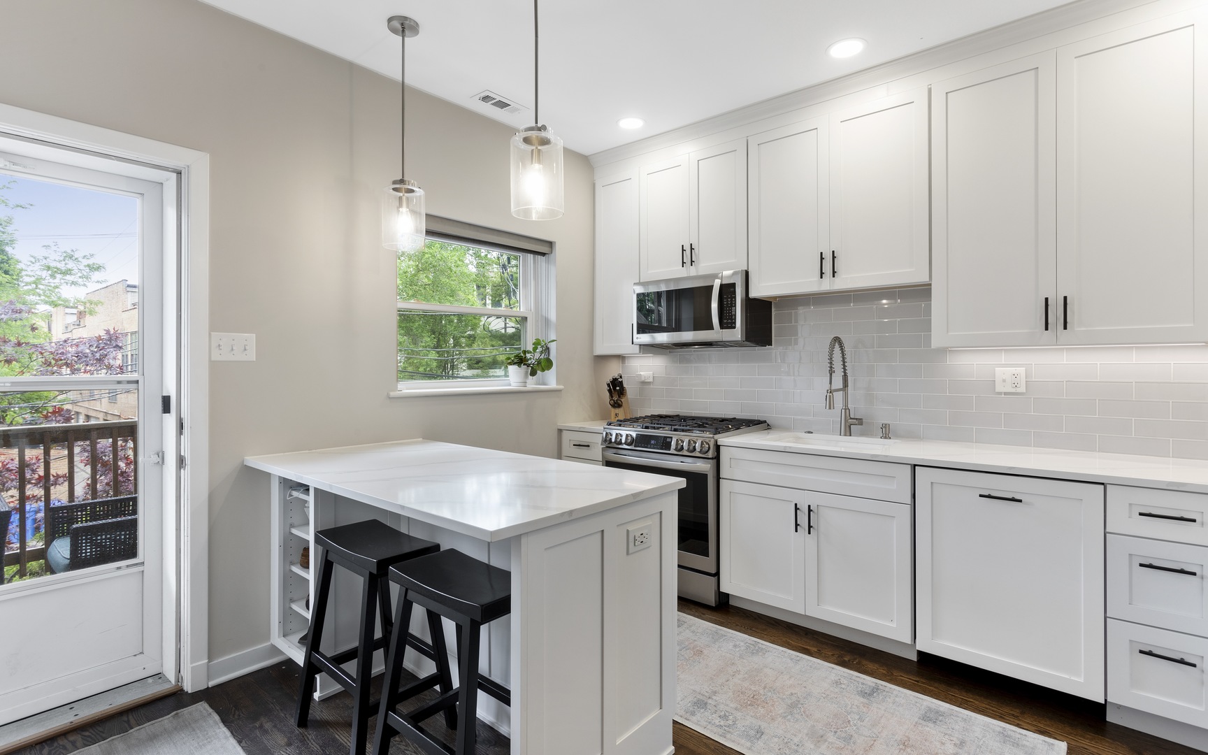 1214 West Webster Avenue, Unit 2E Chicago, IL 60614 - Photo 12 of 23 a kitchen with granite countertop a sink a stove a refrigerator and white cabinets with wooden floor