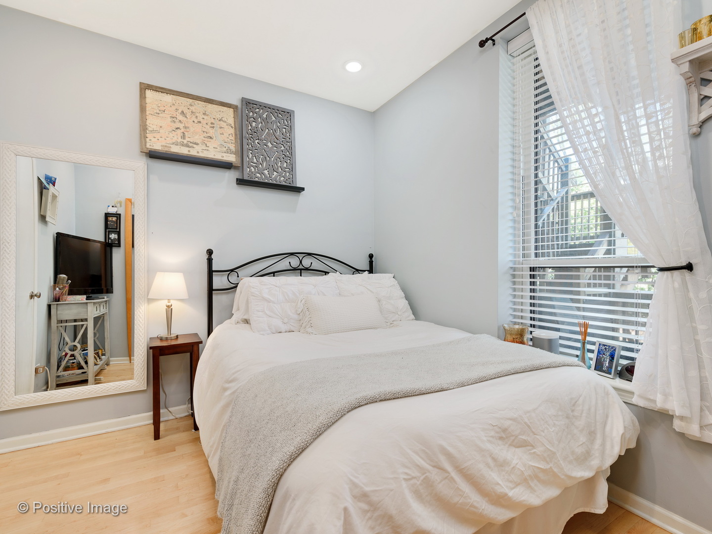 1214 West Webster Avenue, Unit 2E Chicago, IL 60614 - Photo 19 of 23 a bedroom with a bed and a flat screen tv