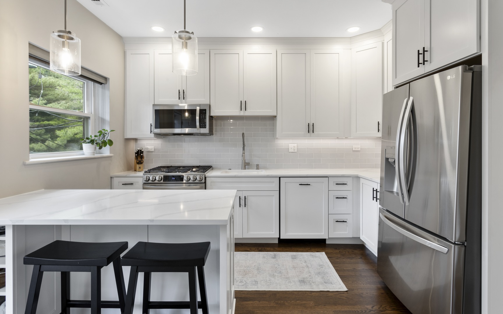 1214 West Webster Avenue, Unit 2E Chicago, IL 60614 - Photo 10 of 23 a kitchen with stainless steel appliances granite countertop a refrigerator a sink dishwasher a stove a refrigerator and white cabinets with wooden floor