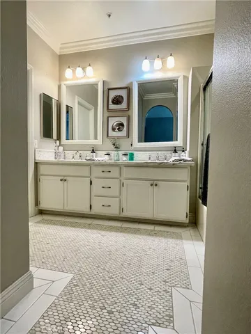 a large bathroom with a large tub sink and mirror