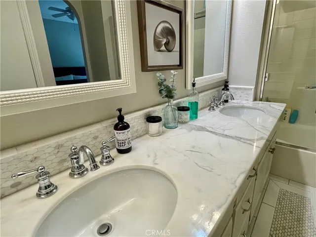 a bathroom with a tub sink and mirror