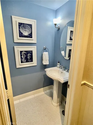 a bathroom with a sink mirror and toilet