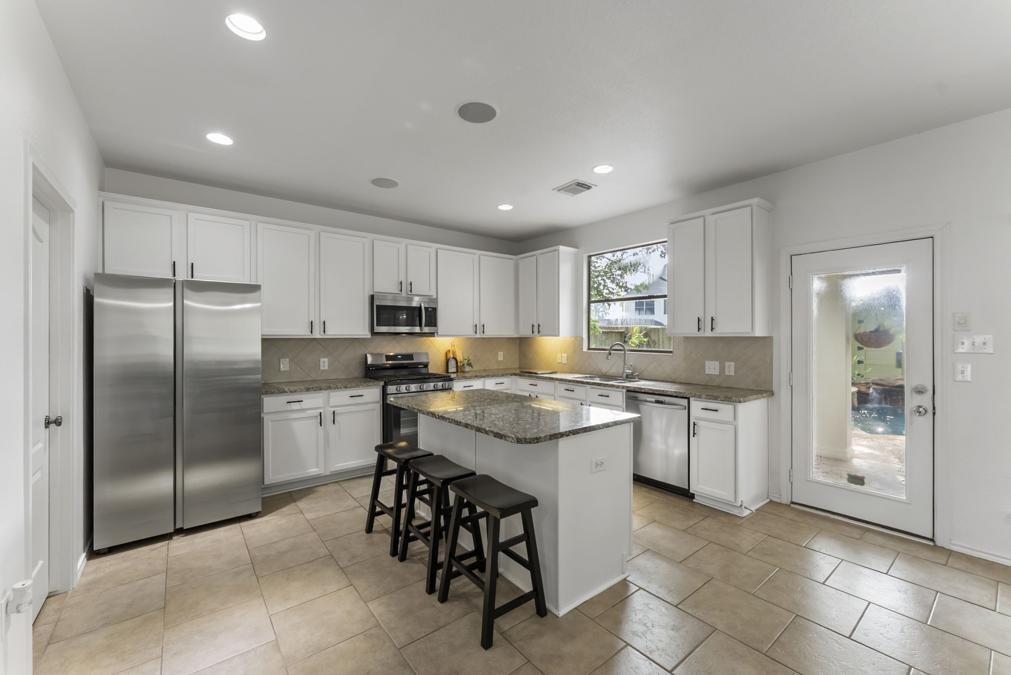 2106 Leaf Meadows Court Spring, TX 77386 - Photo 11 of 34 a kitchen with stainless steel appliances granite countertop a refrigerator and a stove top oven