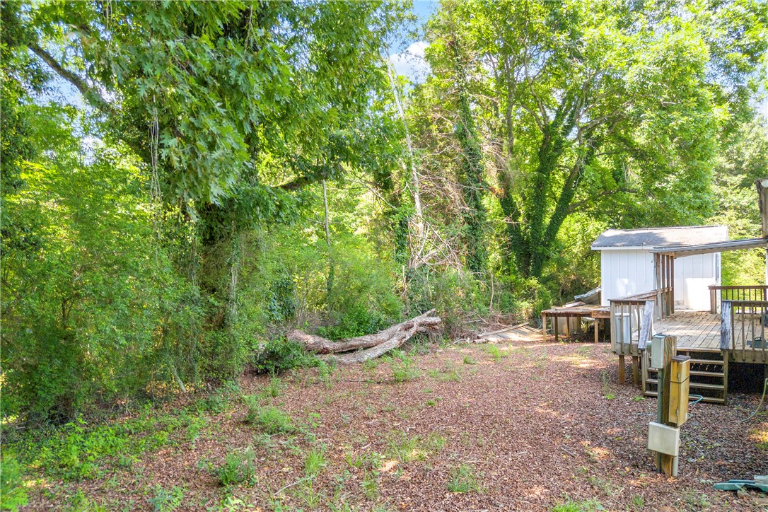 150 Newberry Road Walhalla, SC 29691 - Photo 31 of 47 A spacious backyard with mature trees and a multi-level deck for outdoor enjoyment.