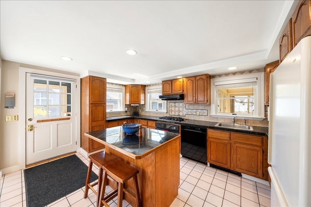 10 2nd Street Natick, MA 01760 - Photo 7 of 31 a kitchen with granite countertop a sink stove and cabinets