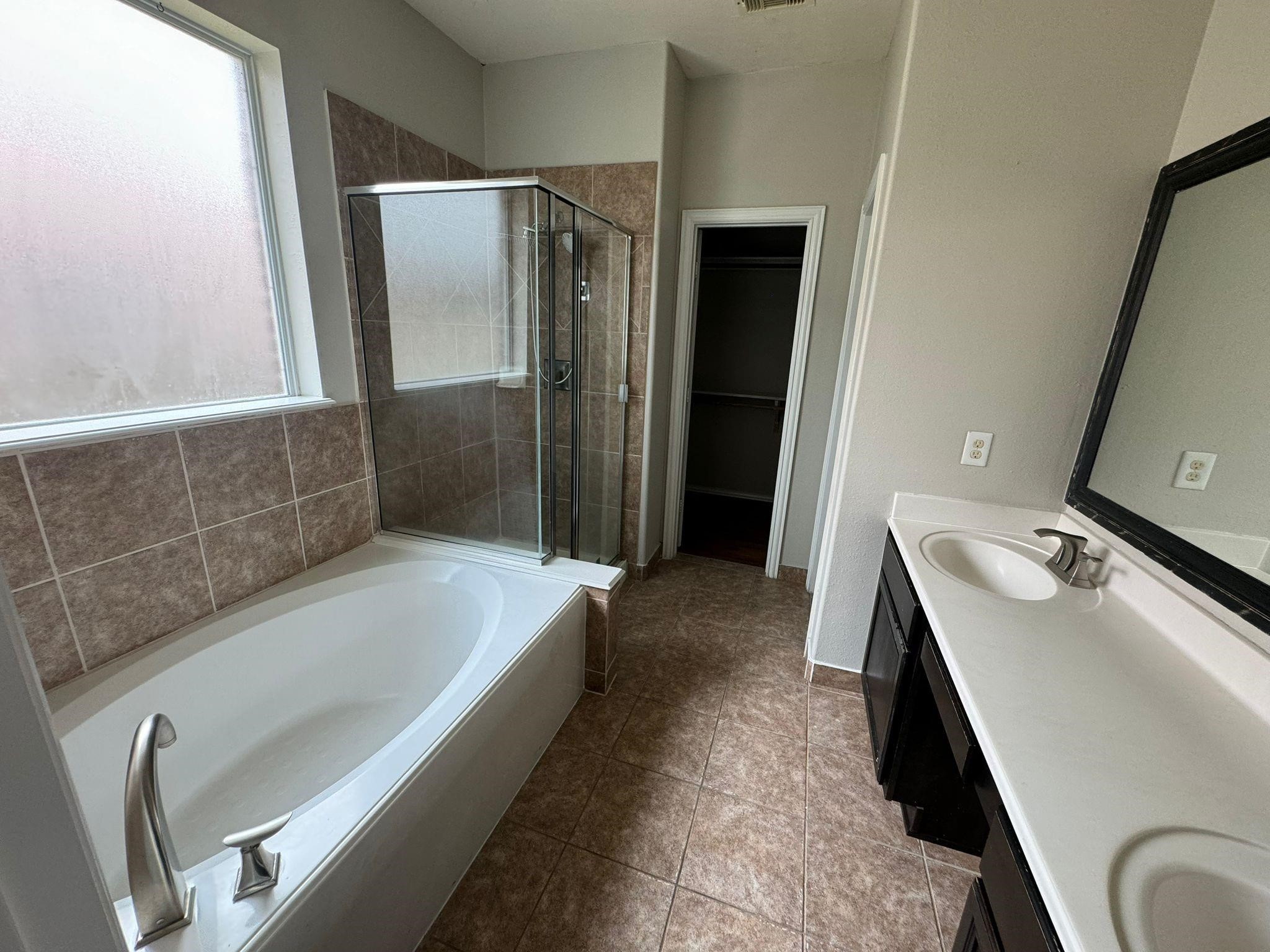 25614 Crisp Spring Lane Spring, TX 77373 - Photo 9 of 25 a bathroom with a tub sink and mirror
