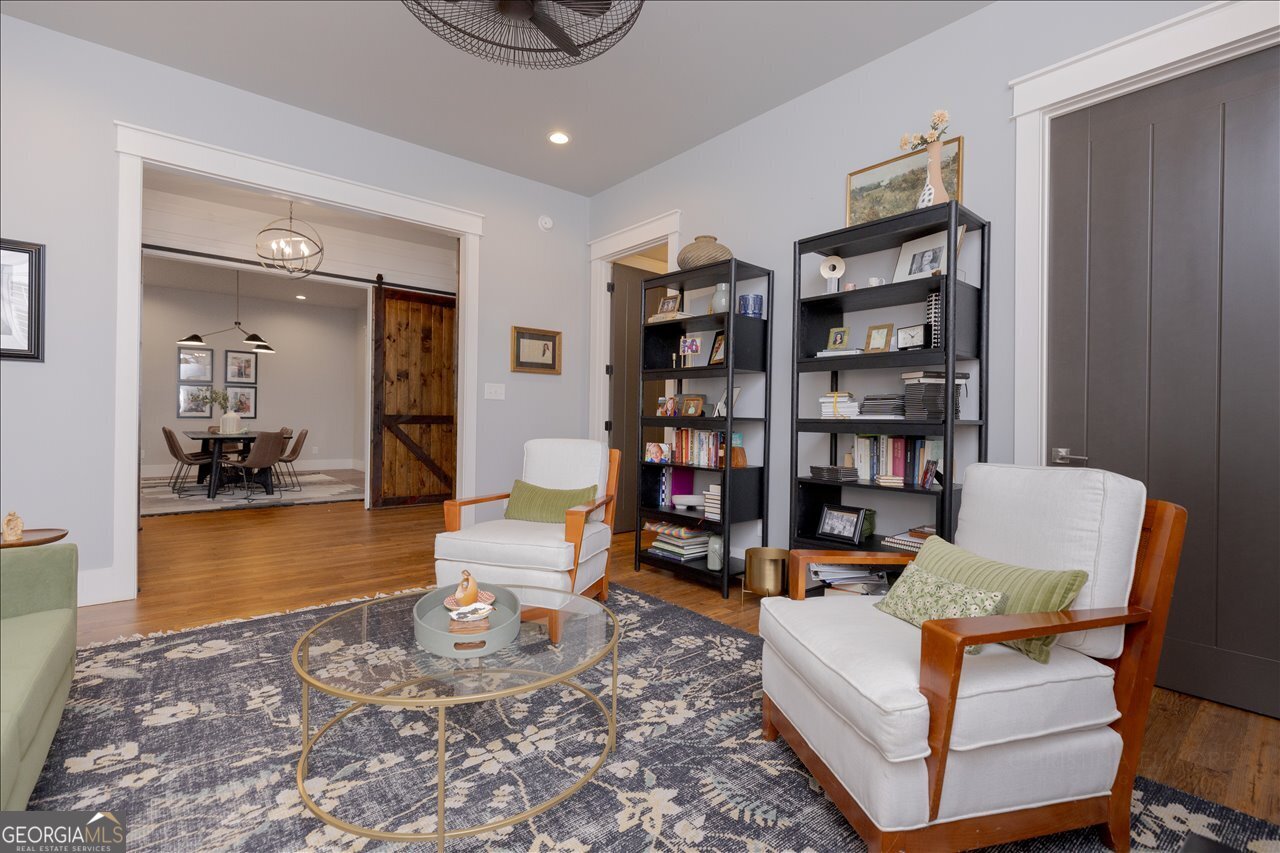 1031 Cherokee Road Perry, GA 31069 - Photo 23 of 104 a living room with furniture and a book shelf