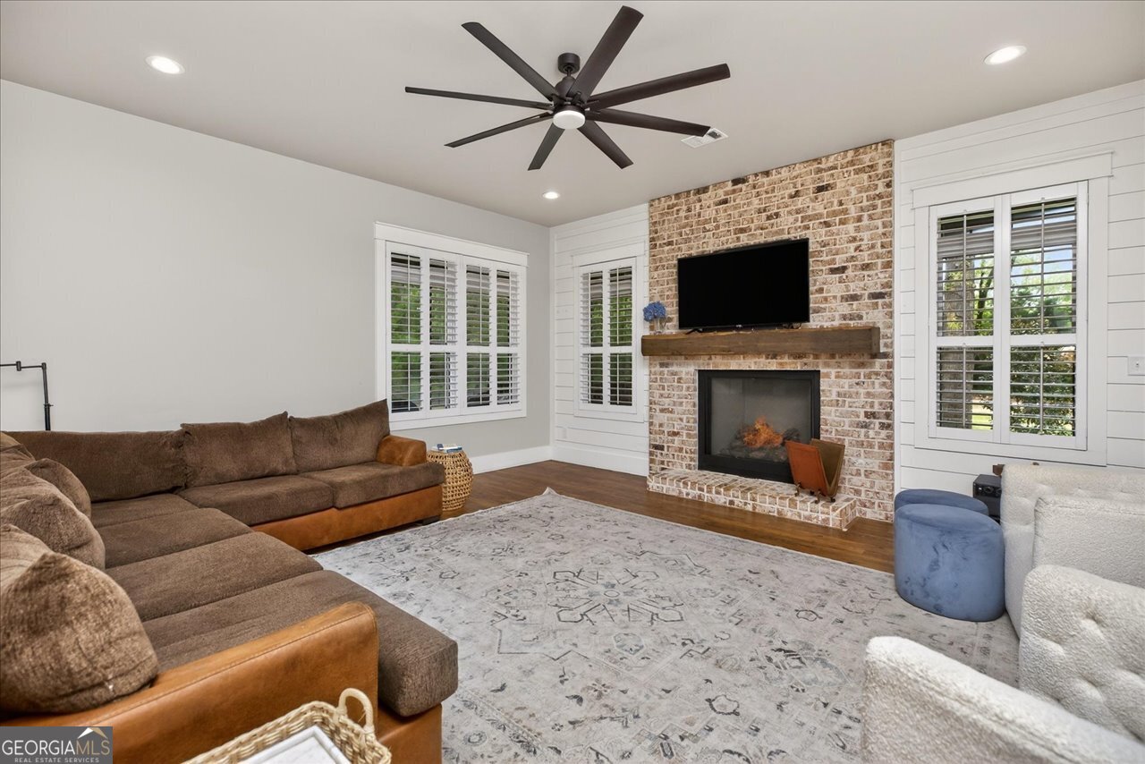 1031 Cherokee Road Perry, GA 31069 - Photo 27 of 104 a living room with furniture a flat screen tv and a fireplace