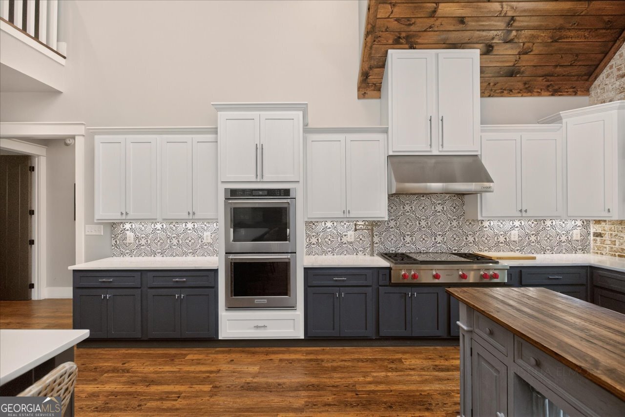 1031 Cherokee Road Perry, GA 31069 - Photo 43 of 104 a kitchen with stainless steel appliances kitchen island granite countertop a sink and cabinets