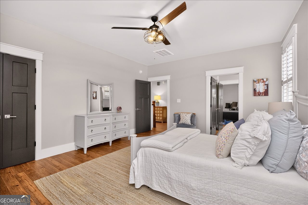 1031 Cherokee Road Perry, GA 31069 - Photo 65 of 104 a bedroom with a bed and a chandelier