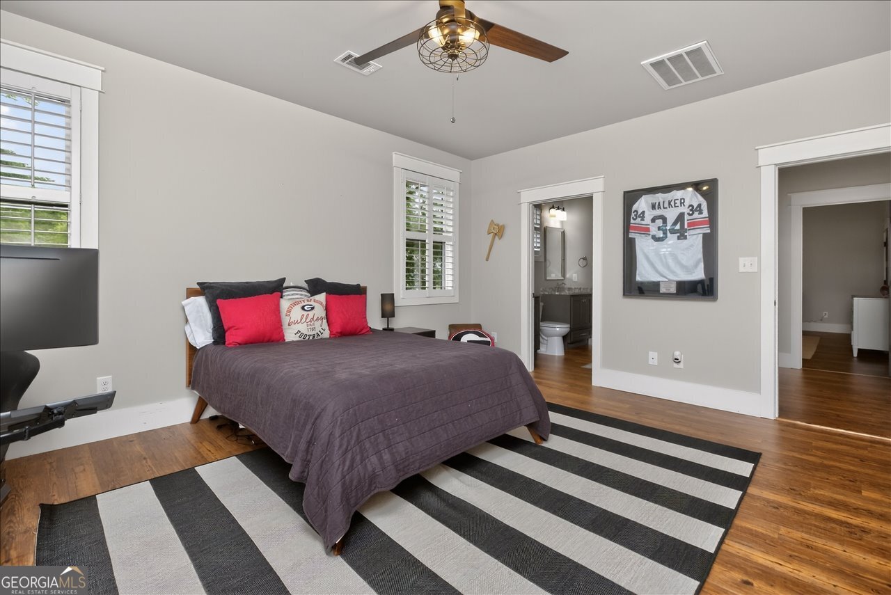 1031 Cherokee Road Perry, GA 31069 - Photo 69 of 104 a bedroom with a bed and wooden floor