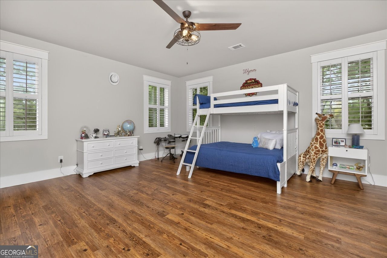 1031 Cherokee Road Perry, GA 31069 - Photo 70 of 104 a bedroom with furniture and a wooden floor