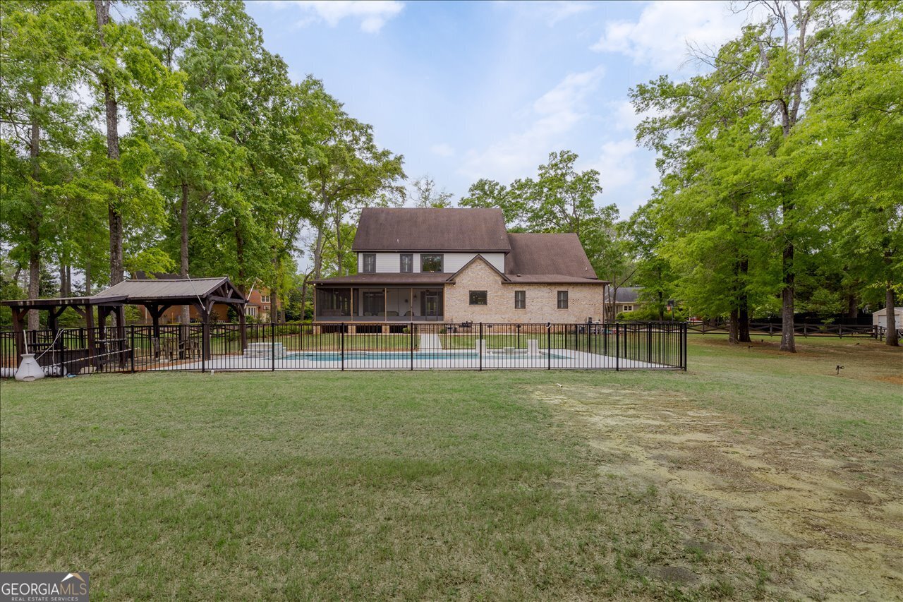 1031 Cherokee Road Perry, GA 31069 - Photo 98 of 104 a front view of a house with a yard and trees