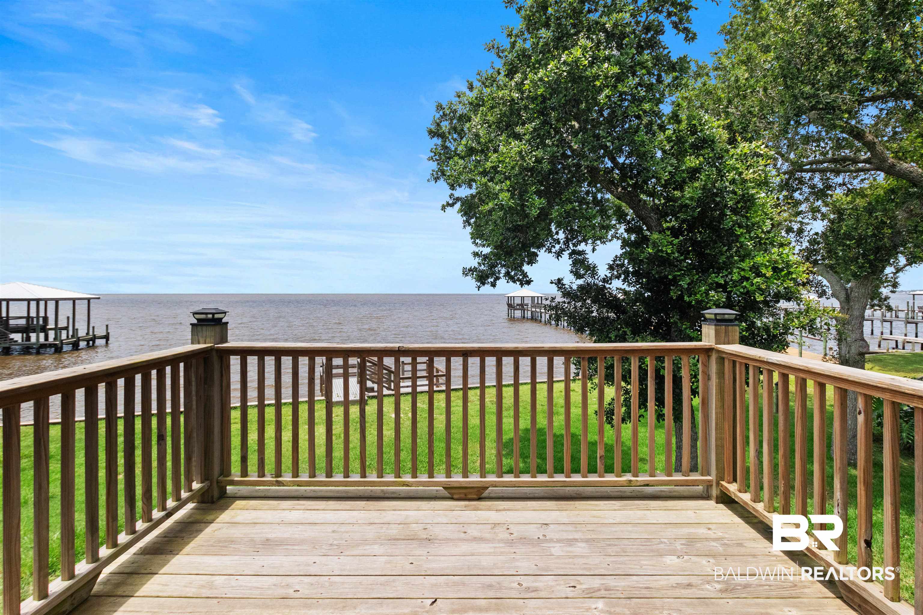 9581 South Bay Street Foley, AL 36535 - Photo 31 of 44 Expansive wood deck with a full railing, overlooking a body of water